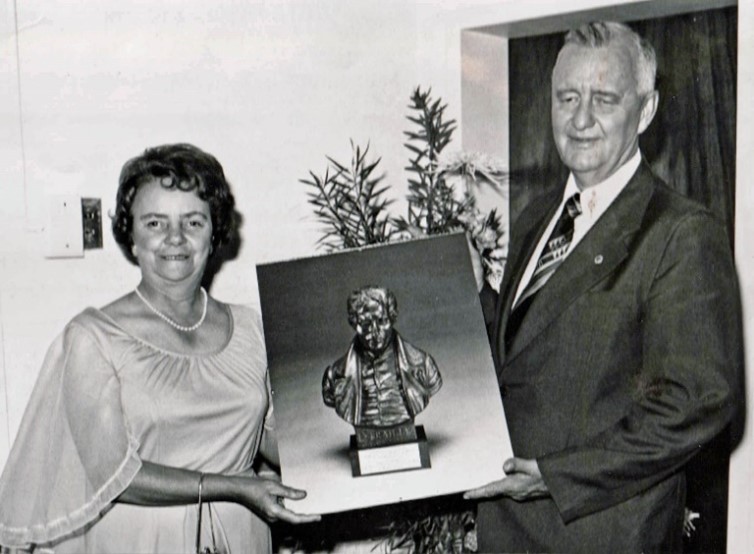 Ms Monica and Mr Ernst Kruger during the opening of the SABWO Head Office and Braille Services building in Mayfair on 12 January 1979. They are holding a painting of a metal portrait sculpture of Louis Braille.