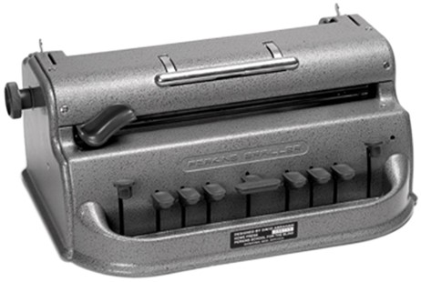 The Perkins Brailler is a "braille typewriter" with a key corresponding to each of the six dots of the braille code, a space key, a backspace key, and a line space key. Like a manual typewriter, it has two side knobs to advance paper through the machine and a carriage return lever above the keys. It is grey in color.