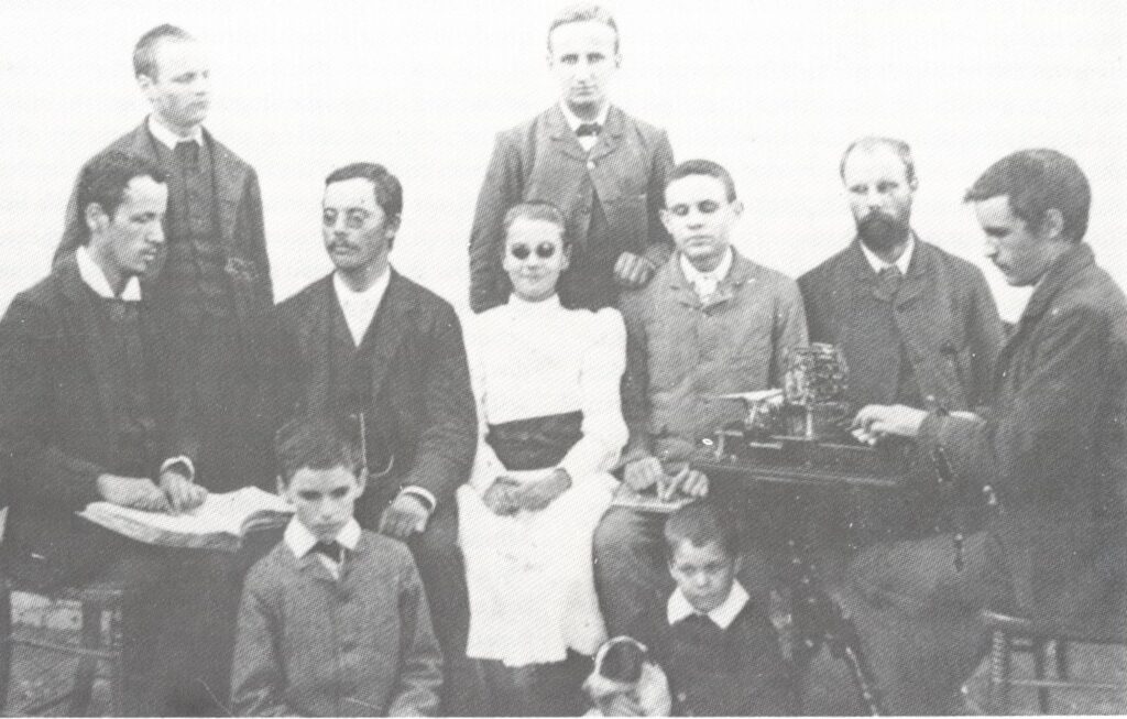 Ten of the first learners at the "Het Doofstommen en Blinden Instituut" in Worcester, pictured with a braille book and first braille stereo writer, imported from England all various ages.