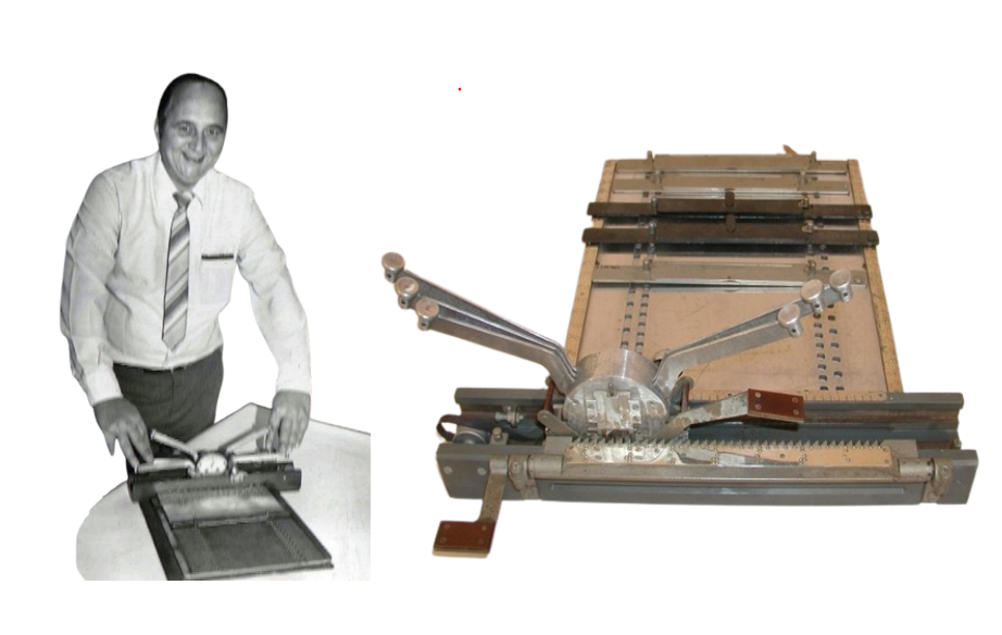 Mr Anton Zeelie using a Crabb Brailler, the brailler has arms/buttons extending beyond the plate where a paper would be placed. He is pressing the buttons and smiling at the photo in black and white.